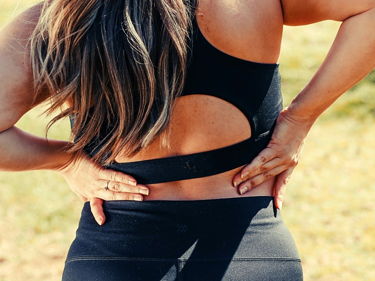 woman holding back due to pain