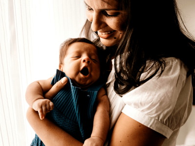woman smiling with newborn