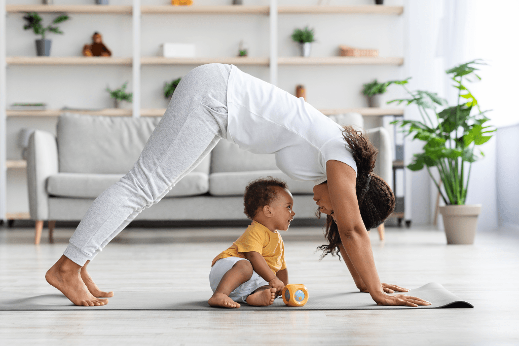 mother doing a yoga pose facing smiling baby